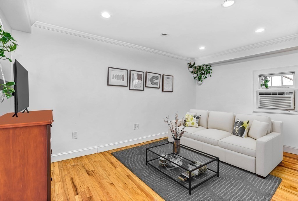16 Addington Road, Unit 23 Brookline, MA 02445 - Photo 8 of 21 a living room with furniture and a rug