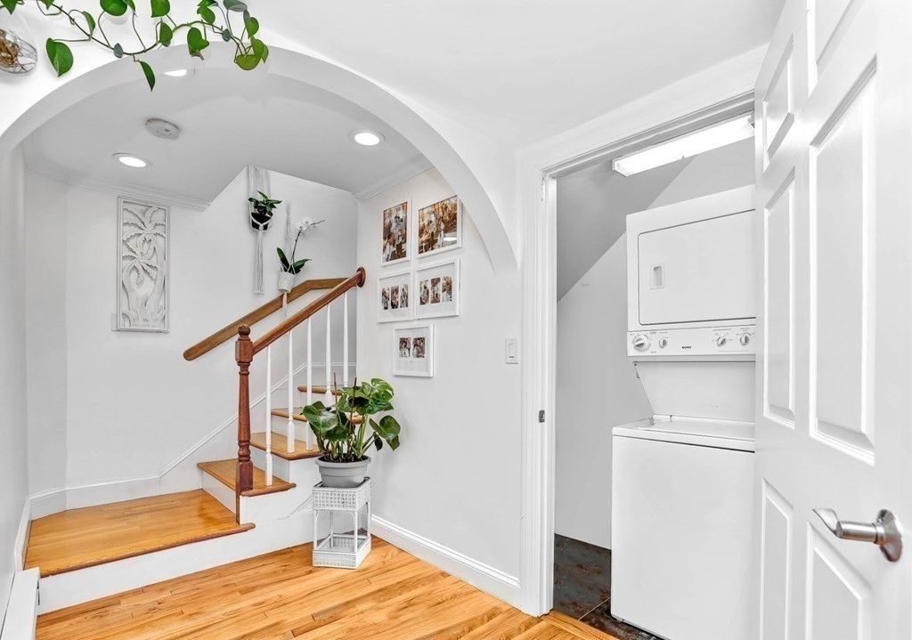 16 Addington Road, Unit 23 Brookline, MA 02445 - Photo 10 of 21 a view of a hallway with wooden floor and a potted plant