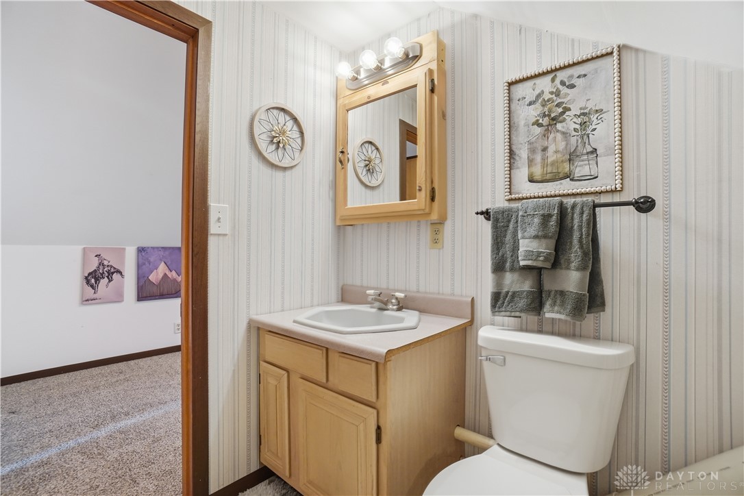 7553 Coffin Station Road Springfield, OH 45502 - Photo 68 of 95 This bright bathroom features ample lighting and a functional vanity, offering comfort and convenience.