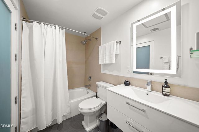 a bathroom with a toilet a sink and a mirror