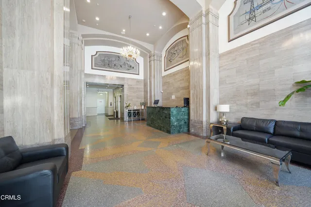 a lobby with furniture and floor to ceiling window