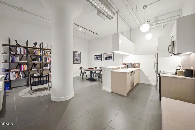 a kitchen with cabinets and chairs