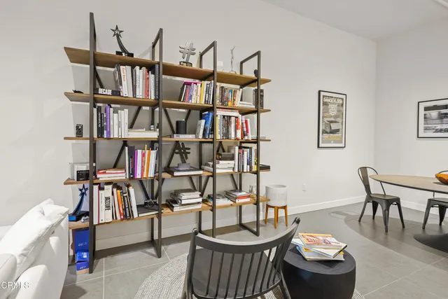 a view of a dining room with furniture and a kitchen