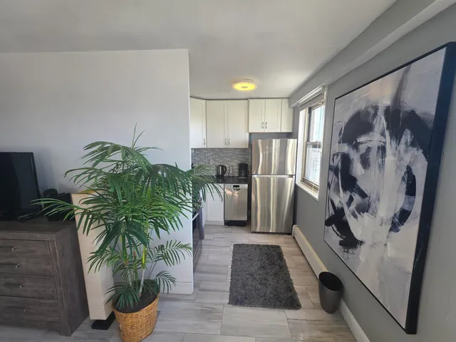 a kitchen with stainless steel appliances a stove a refrigerator and a sink