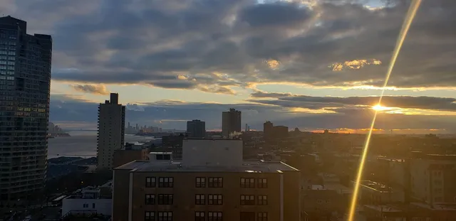 a kitchen with stainless steel appliances granite countertop a refrigerator a stove and a wooden floors