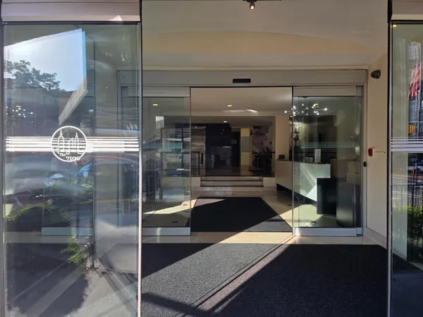 a room with lot of cabinets and glass door