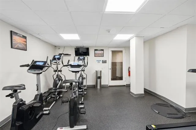 a room with gym equipment and windows