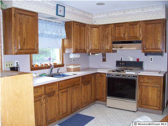 404 Cook Road Jackson, NJ 08527 - Photo 3 of 3 a kitchen with stainless steel appliances granite countertop a sink stove and refrigerator