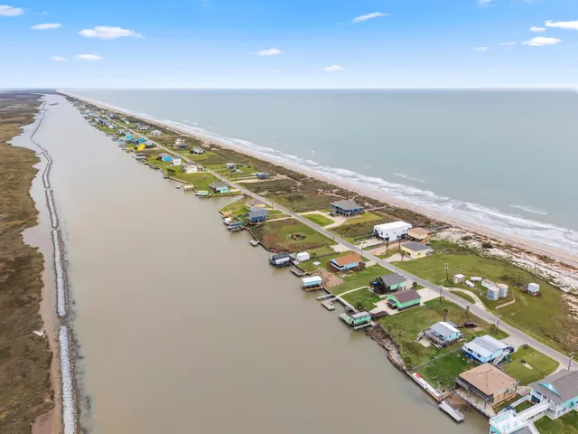 a kitchen with stove a sink and dining table with granite countertop chairs