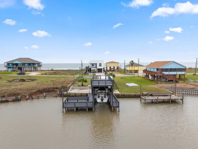 a kitchen with stainless steel appliances granite countertop a sink a stove a refrigerator and island