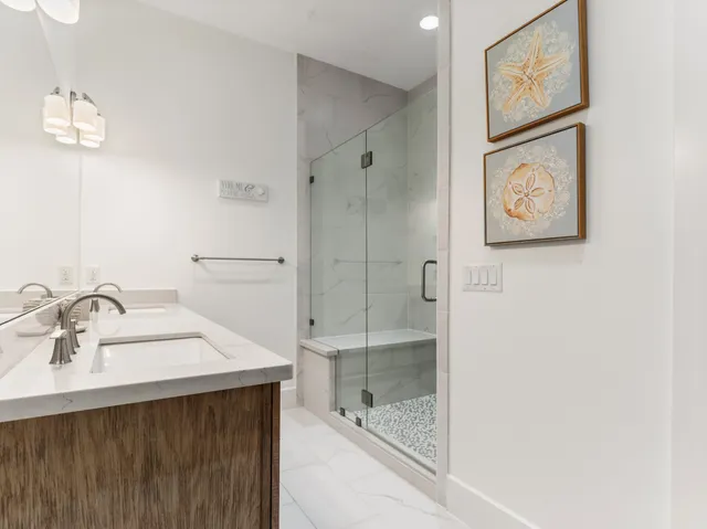 a bathroom with a tub sink and mirror