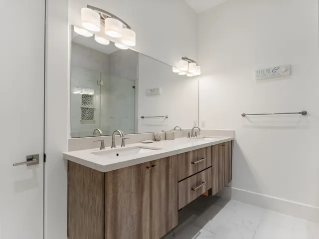 a bathroom with a double vanity sink and a mirror