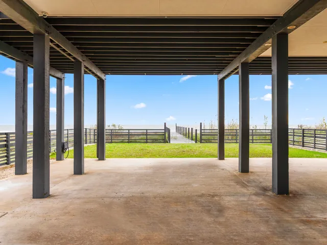 a view of a roof deck with dining table and chairs