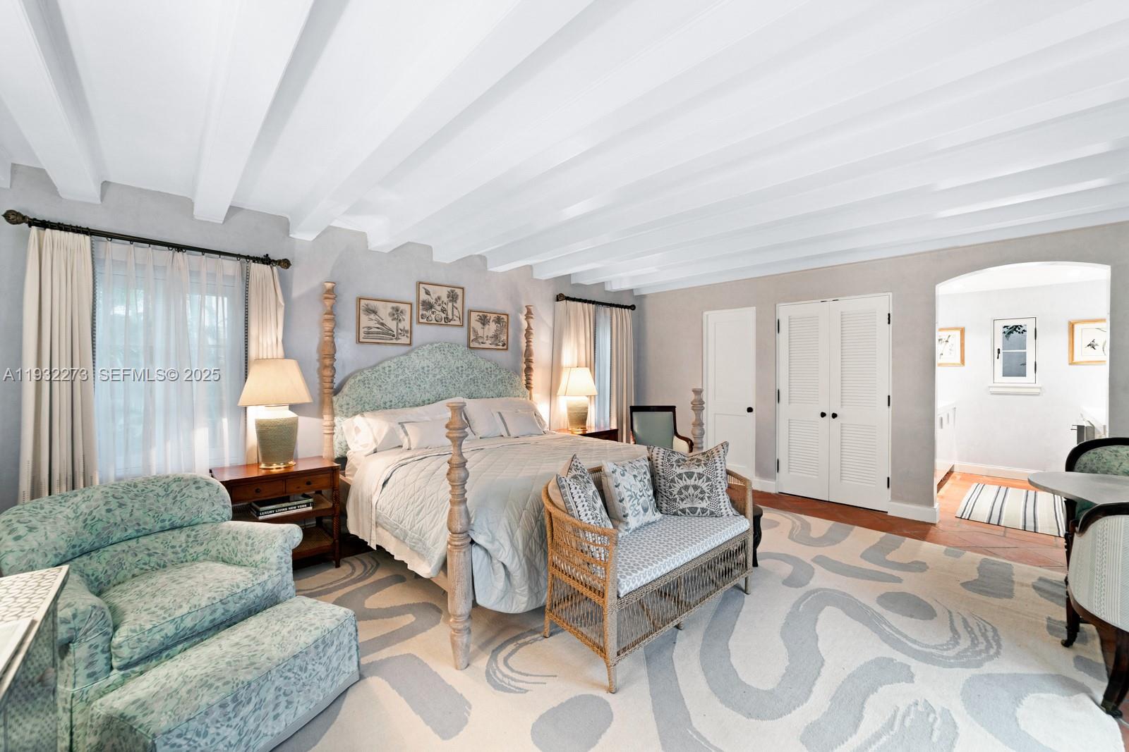 3467 North Moorings Way Miami, FL 33133 - Photo 12 of 25 a spacious bedroom with a bed a couch and a large window