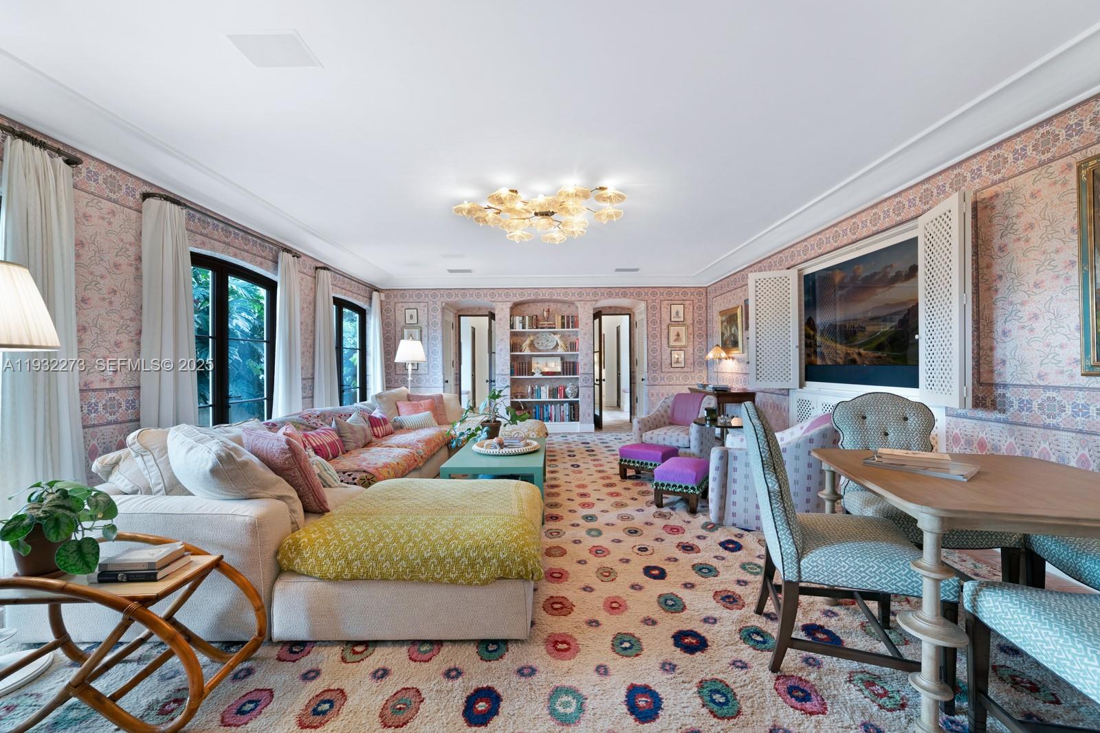 3467 North Moorings Way Miami, FL 33133 - Photo 4 of 25 a living room with furniture a flat screen tv and a table