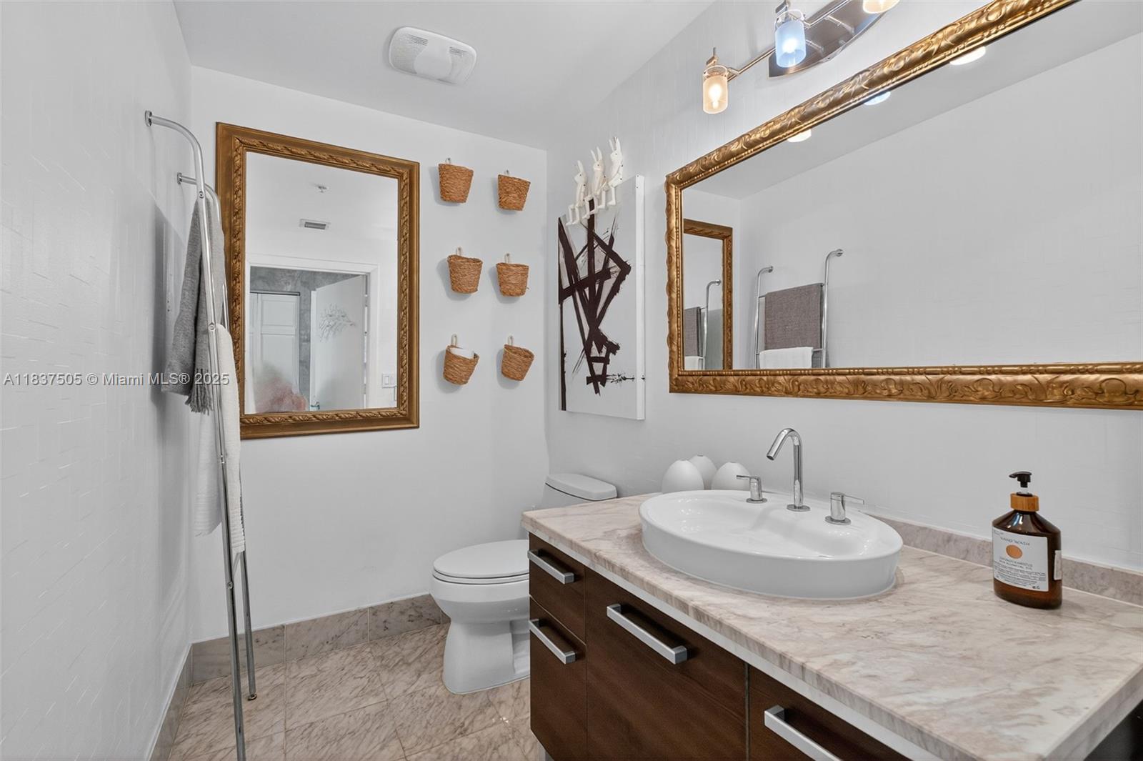 244 Biscayne Boulevard, Unit 446 Miami, FL 33132 - Photo 3 of 22 a bathroom with a granite countertop sink and a mirror