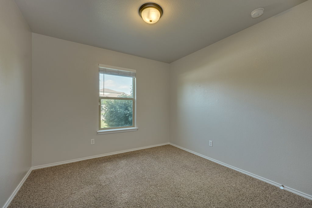 210 Cushman Drive Kyle, TX 78640 - Photo 17 of 21 Neutral toned walls with textured finishes