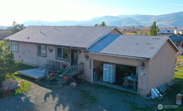 an aerial view of a house with table and chairs