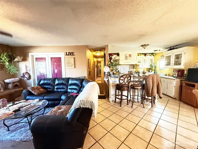 a living room with furniture a dining table and chairs