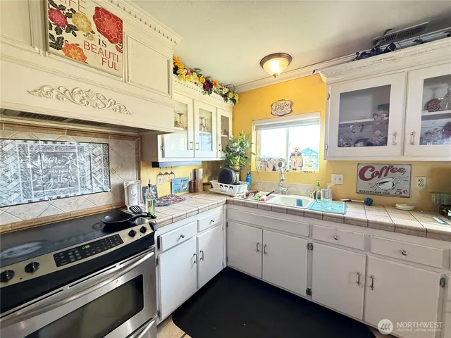 a kitchen with a sink stove and cabinets