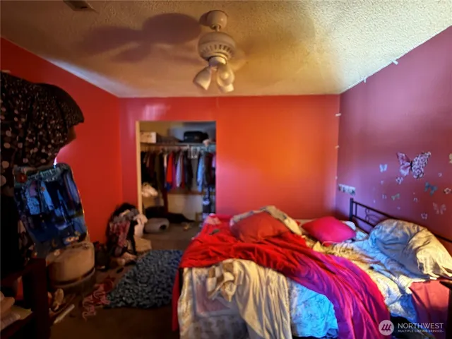 a bedroom with a bed and a lamp