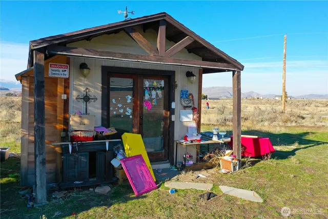 a view of a house with a porch and furniture