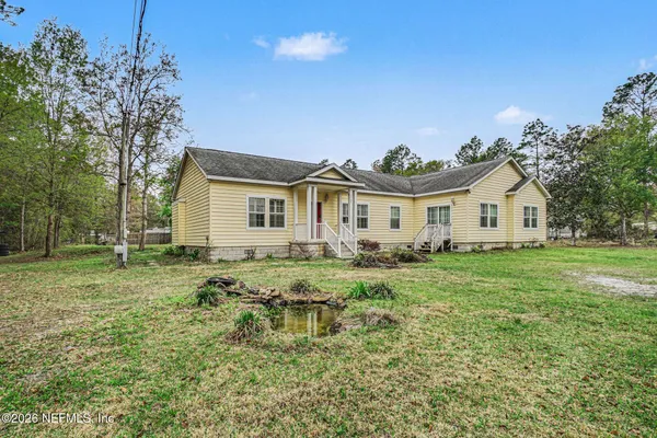 a view of a house with a yard