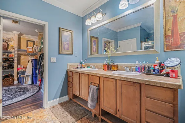 a bathroom with a sink vanity and a mirror
