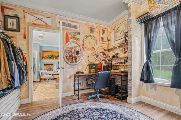 a view of a workspace with furniture and a window