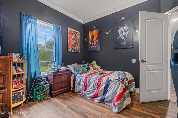 a bed sitting in a bedroom next to a window