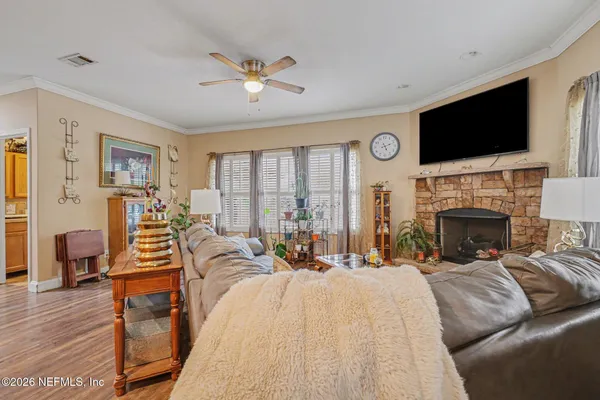 a bedroom with a bed a flat screen tv and a fireplace