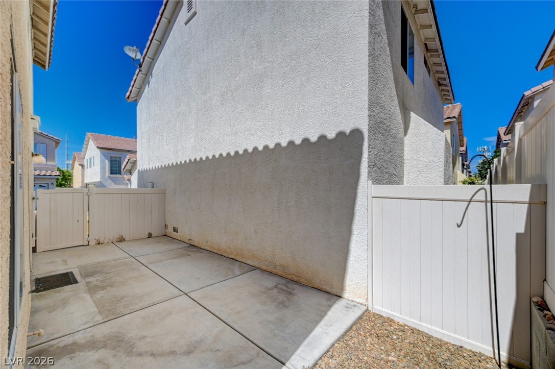 7259 Cestrum Road Las Vegas, NV 89113 - Photo 29 of 35 A well-maintained side yard with a sturdy privacy fence provides an intimate outdoor space.
