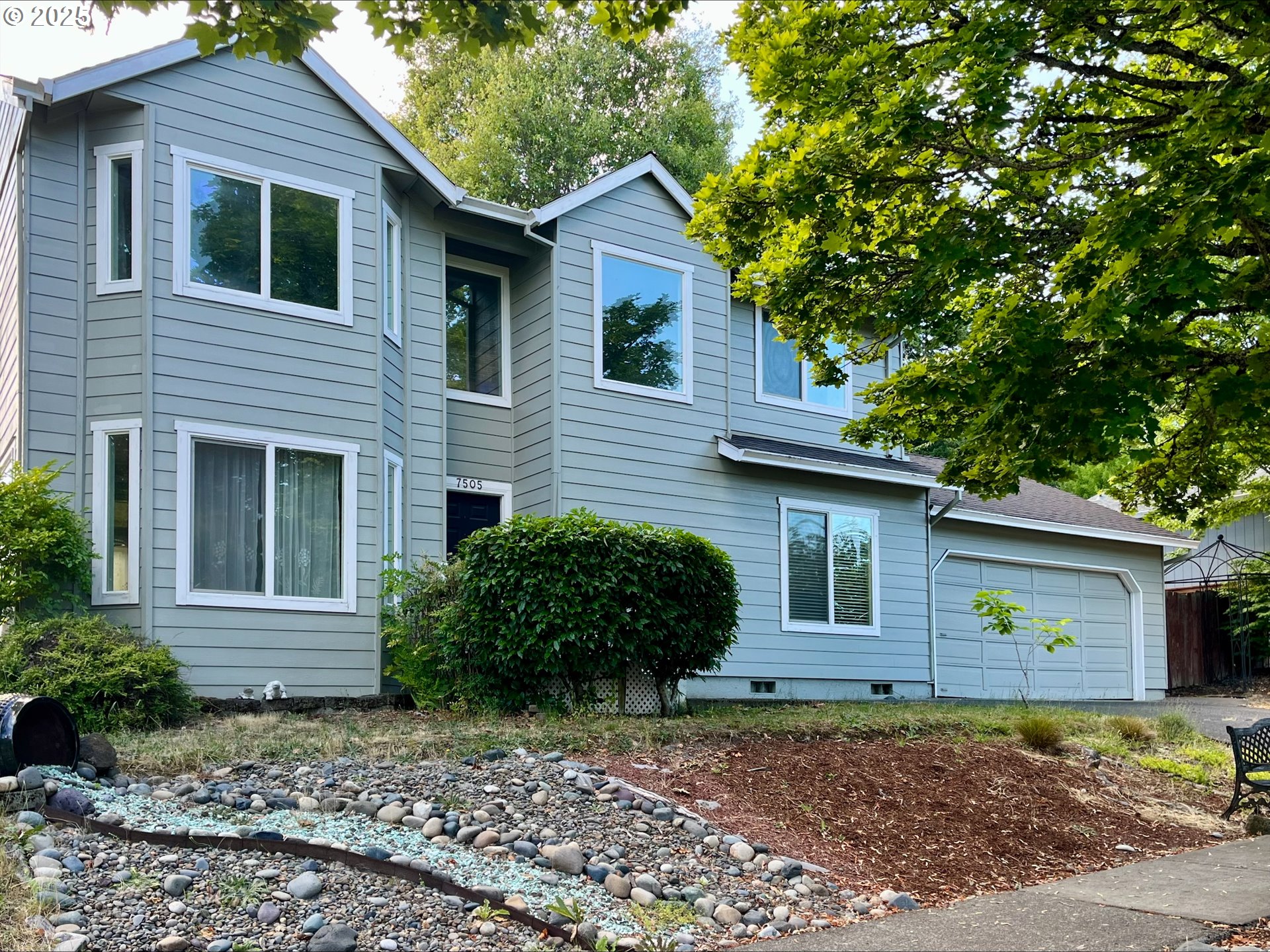 7505 Southwest Alpine Drive Beaverton, OR 97008 - Photo 1 of 48 a front view of a house with garden