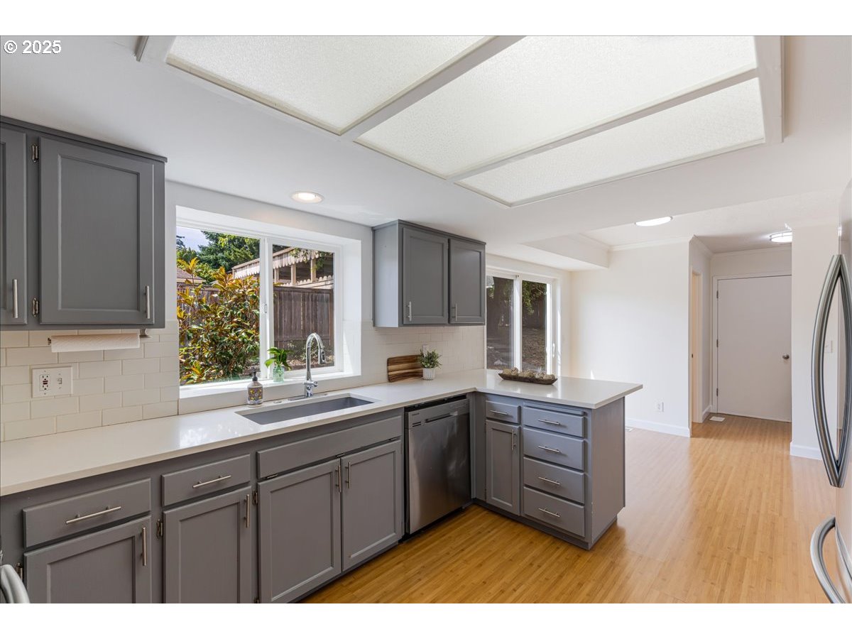 7505 Southwest Alpine Drive Beaverton, OR 97008 - Photo 12 of 48 a kitchen with lots of counter top space and wooden floor
