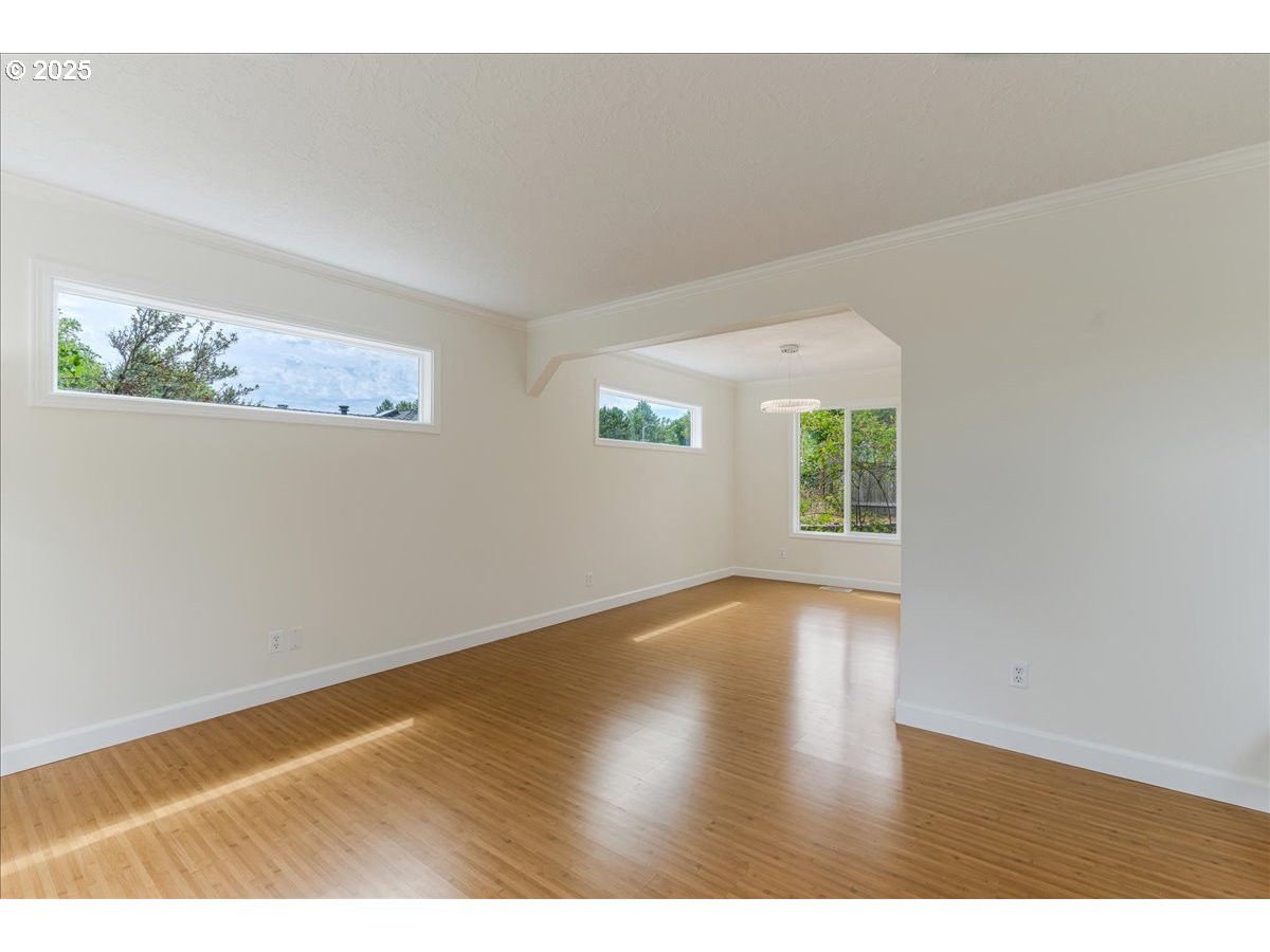 7505 Southwest Alpine Drive Beaverton, OR 97008 - Photo 18 of 48 an empty room with wooden floor and windows
