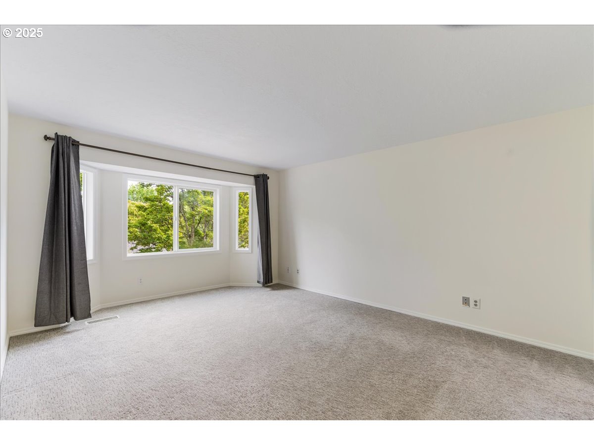 7505 Southwest Alpine Drive Beaverton, OR 97008 - Photo 22 of 48 a view of a big room with windows and chandelier