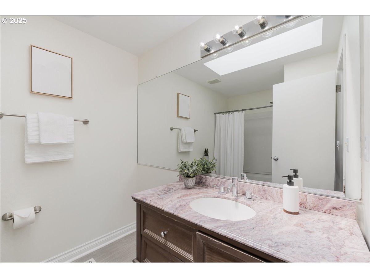 7505 Southwest Alpine Drive Beaverton, OR 97008 - Photo 25 of 48 a bathroom with a granite countertop sink a mirror and a