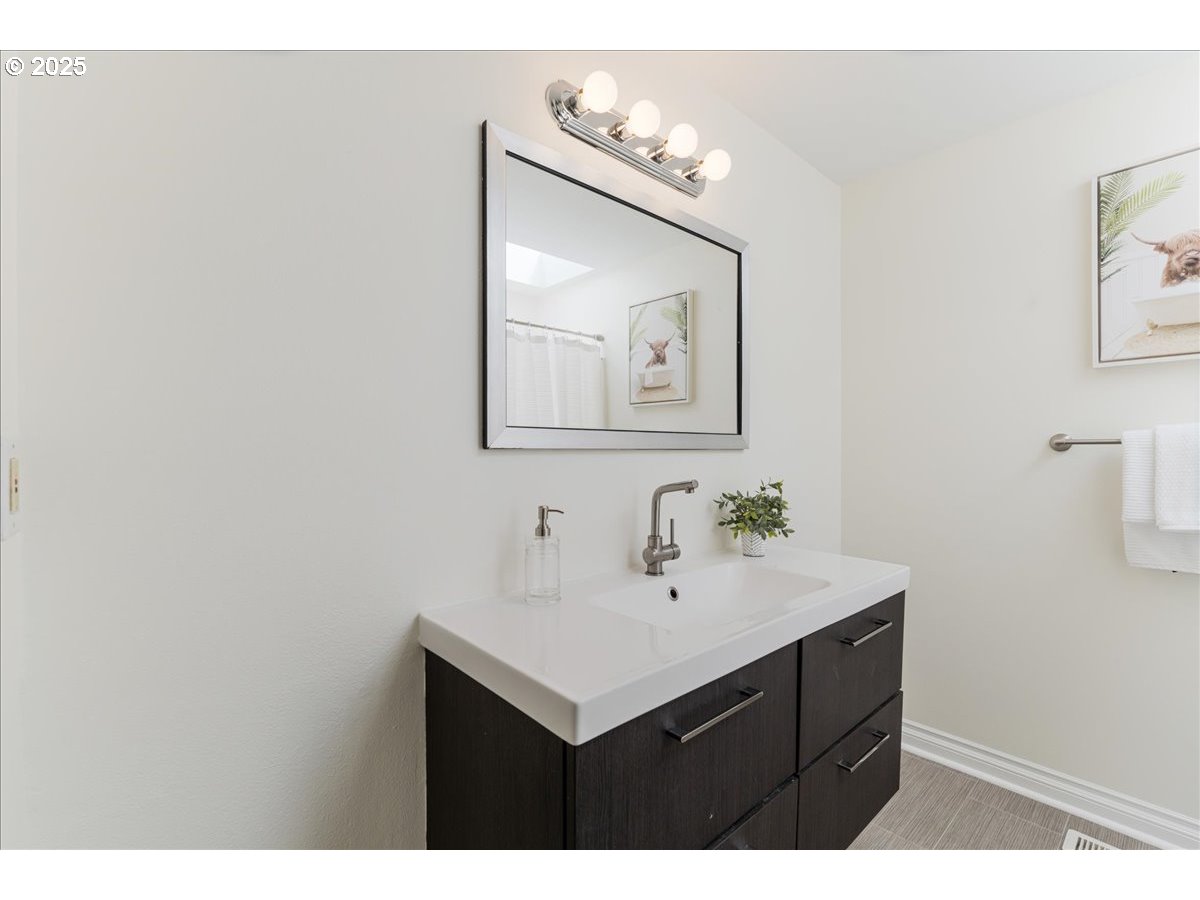 7505 Southwest Alpine Drive Beaverton, OR 97008 - Photo 29 of 48 a bathroom with a sink vanity and a mirror
