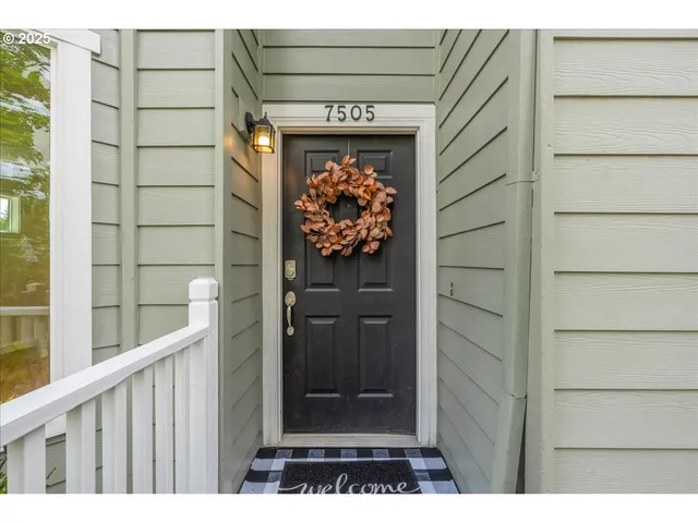 a view of an entryway with wooden floor