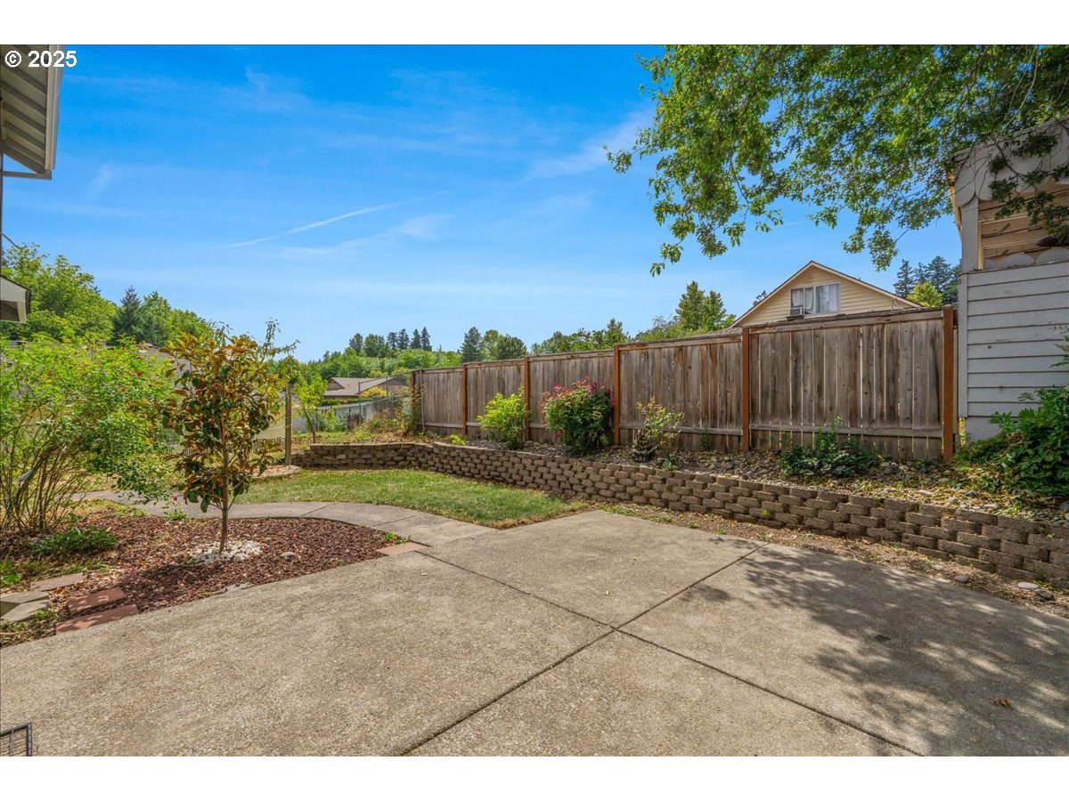 7505 Southwest Alpine Drive Beaverton, OR 97008 - Photo 34 of 48 a view of backyard with large trees and wooden fence