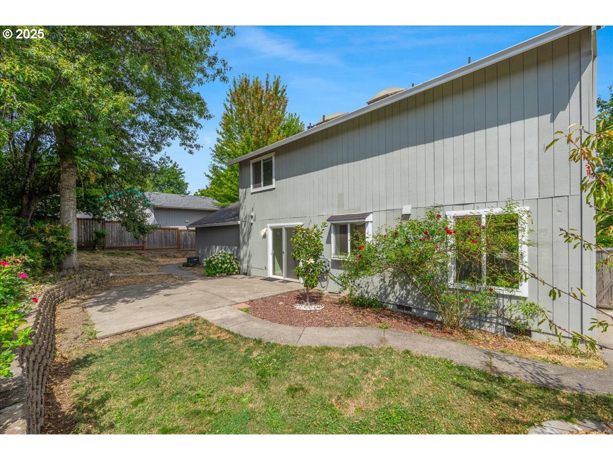 7505 Southwest Alpine Drive Beaverton, OR 97008 - Photo 35 of 48 a view of a backyard with table and chairs and potted plants
