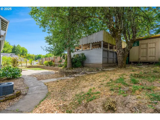 a backyard of a house with table and chairs