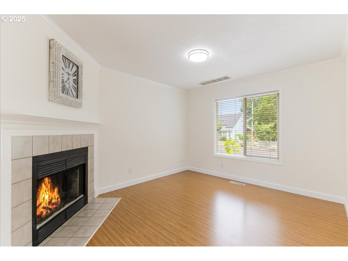 7505 Southwest Alpine Drive Beaverton, OR 97008 - Photo 5 of 48 a view of an empty room with window and fire place