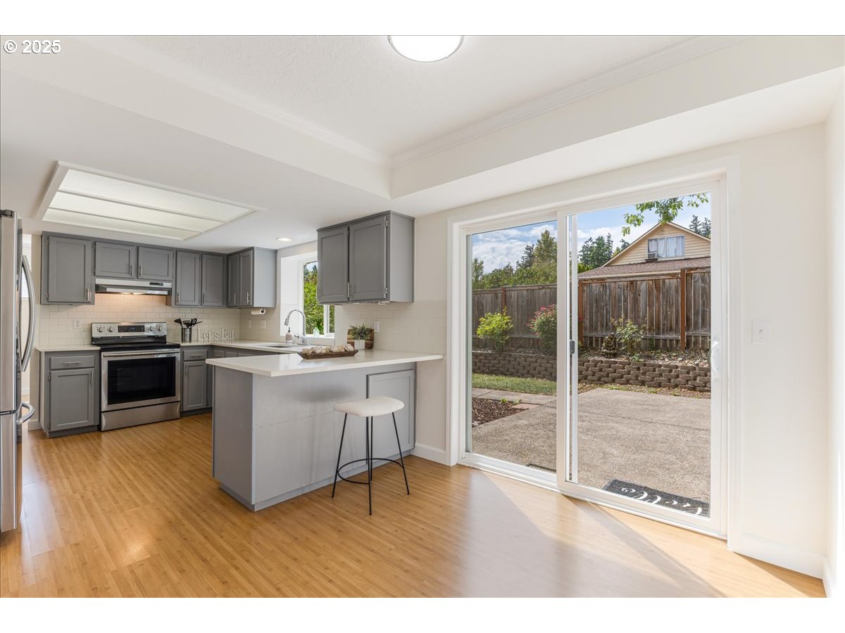 7505 Southwest Alpine Drive Beaverton, OR 97008 - Photo 8 of 48 a kitchen with a sink stainless steel appliances and cabinets