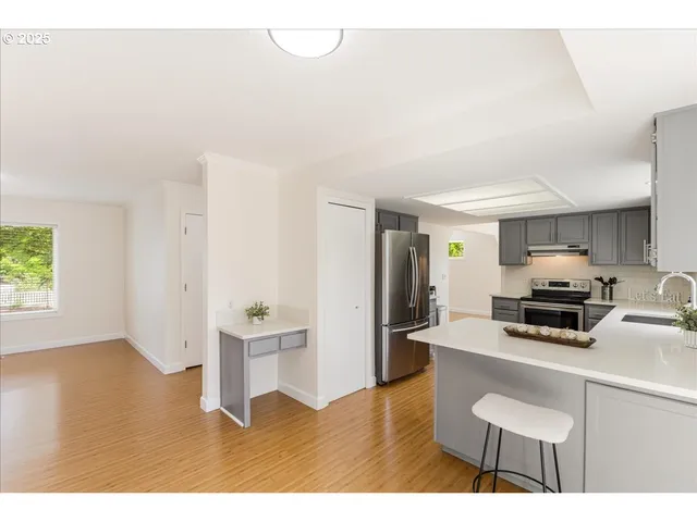 a kitchen with a sink stove top oven and cabinets