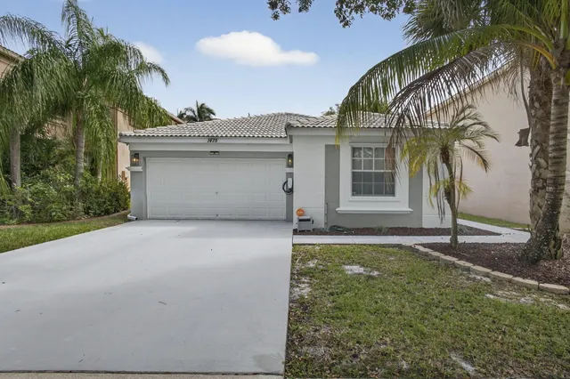 a view of a house with a yard and garage