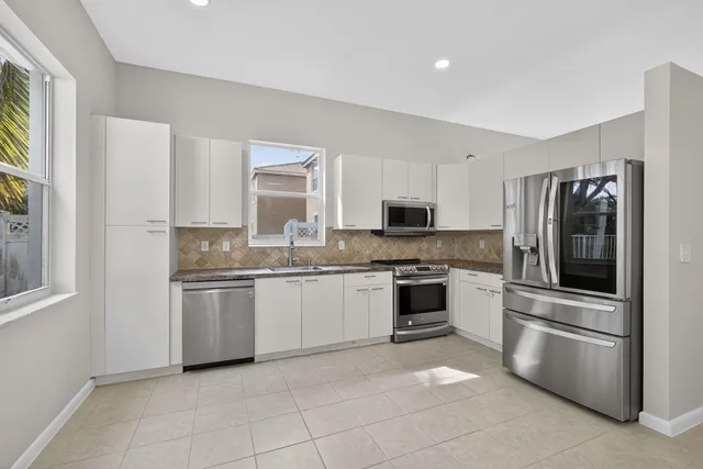 a kitchen with a refrigerator stove and microwave
