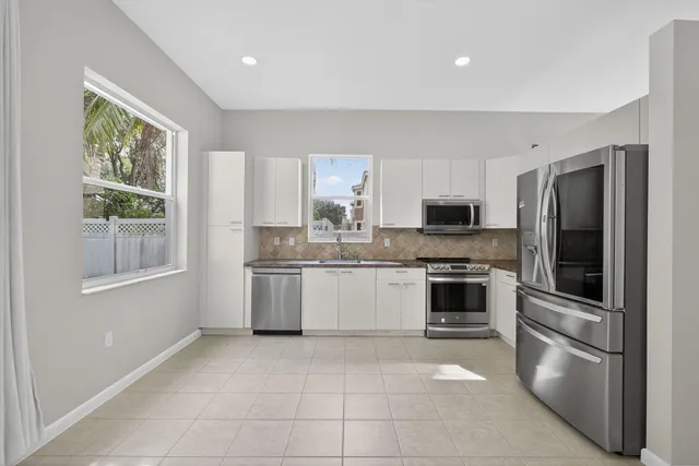 a kitchen with stainless steel appliances granite countertop a sink stove and microwave