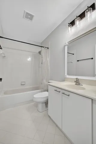 an empty room with a window and wooden floor