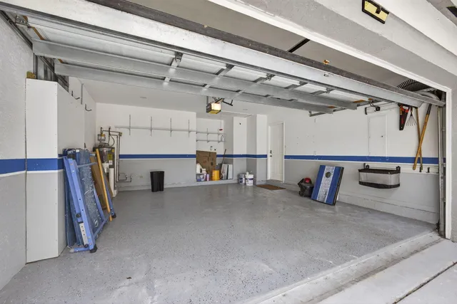 an aerial view of a house with a garden and lake view